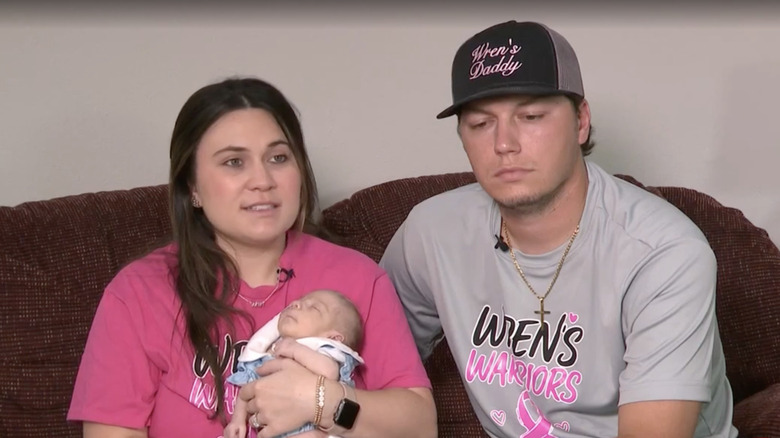 Savannah Roberts holding her newborn daughter, Wren, and sitting next to her husband, Nick Roberts