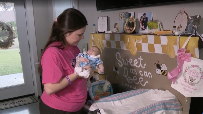 Savannah Roberts looking at and holding her newborn daughter Wren Roberts