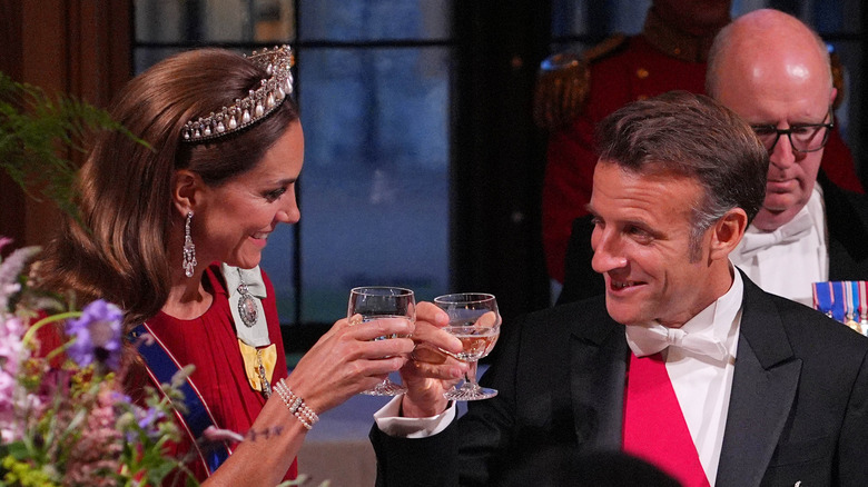 Catherine, Princess of Wales cheers-ing with Emmanuel Macron