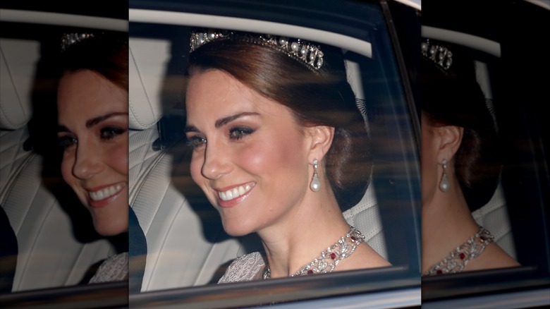Kate Middleton riding in a car to an event for King Felipe and Queen Letizia of Spain in 2017