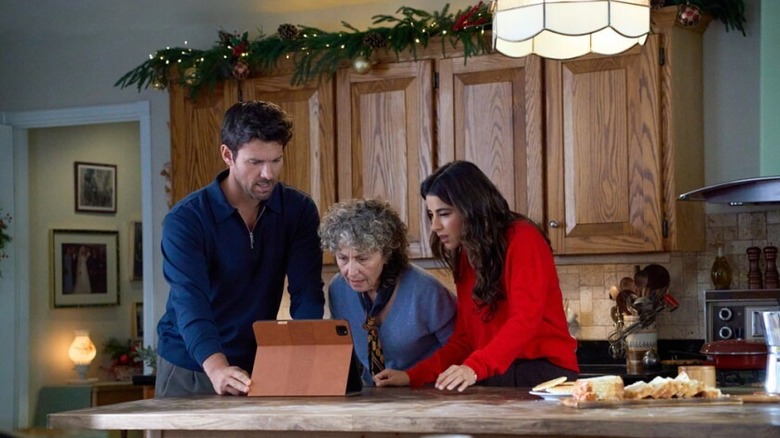 Daniella Monet and Kevin McGarry looking at an iPad