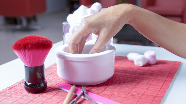 woman soaking fingernails