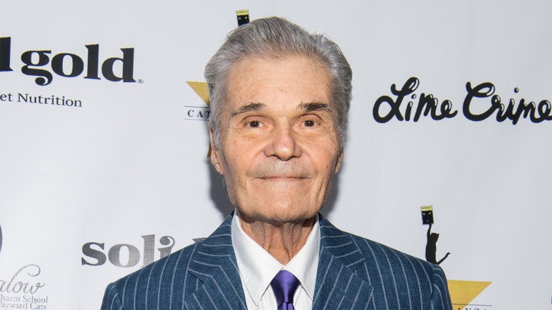Fred Willard walks a red carpet in 2018