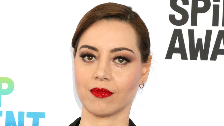 Aubrey Plaza posing at a red carpet event
