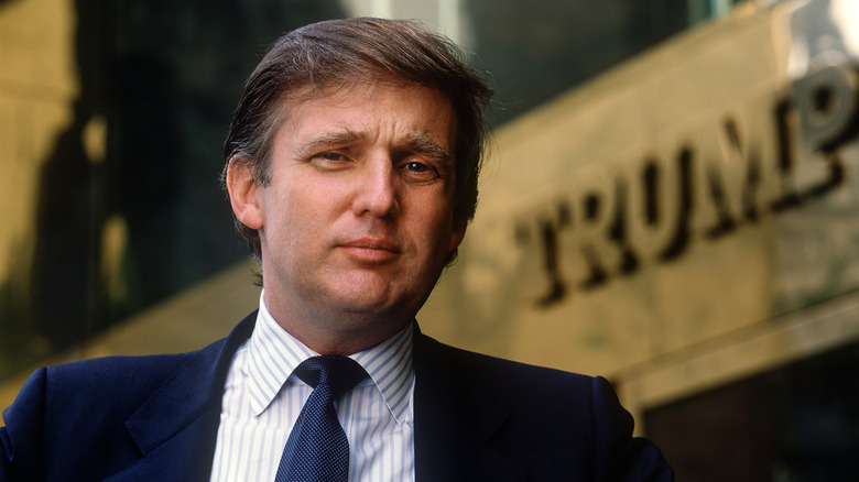 Donald Trump standing in front of New York's Trump Tower.