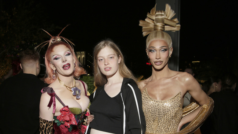 Bosco, Vivian Wilson, and Kerri Colby posing at an event together