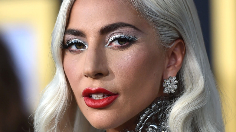 Lady Gaga looks over her shoulder on the red carpet