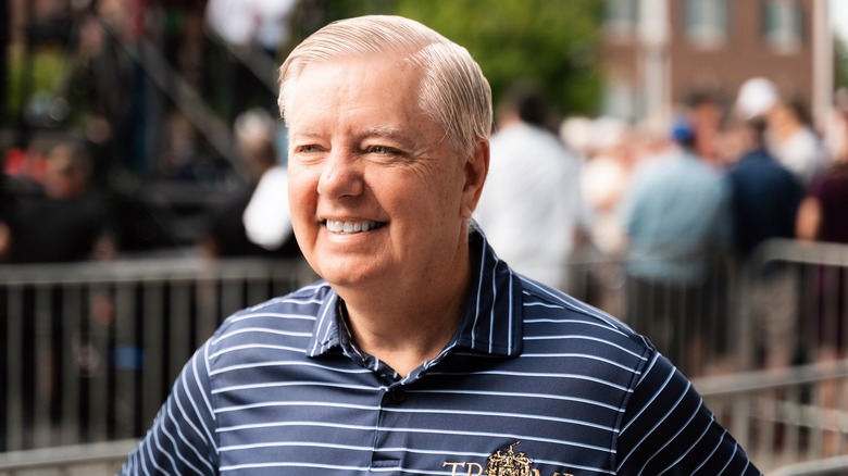 Lindsey Graham smiling while wearing a striped shirt