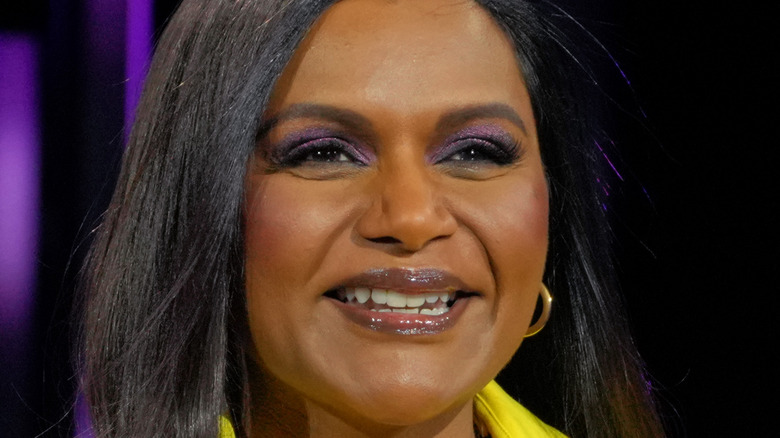 Mindy Kaling smiling while at an event