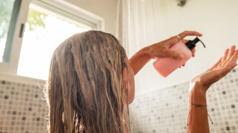 woman pumping shampoo in shower