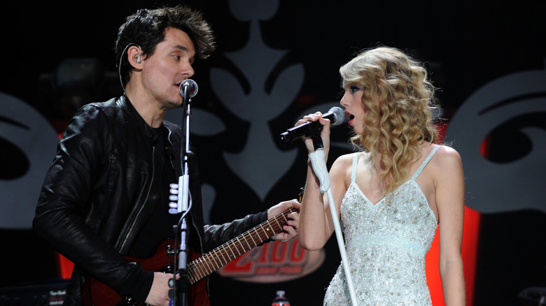 John Mayer and Taylor Swift singing on stage at the Jingle Ball in 2009.