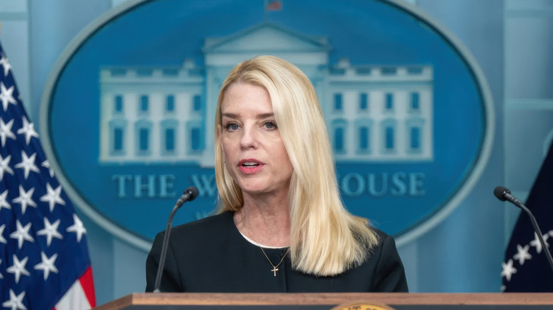 Pam Bondi speaking at the White House emblem in the background
