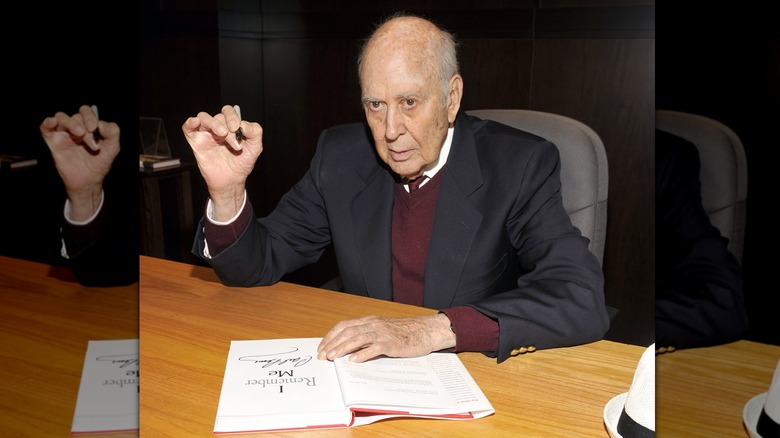 Carl Reiner signing copies of a book he wrote in 2013