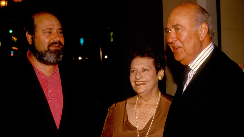 Carl, Estelle, and Rob Reiner leaving a hotel