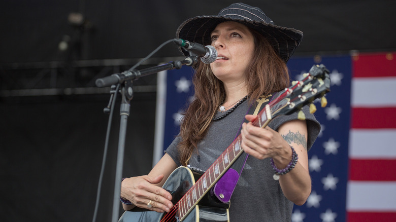 Amy Lee Nelson singing in front of an American flag