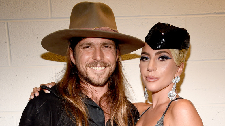 Lady Gaga with her hand on a smiling Lukas Autry Nelson's shoulder