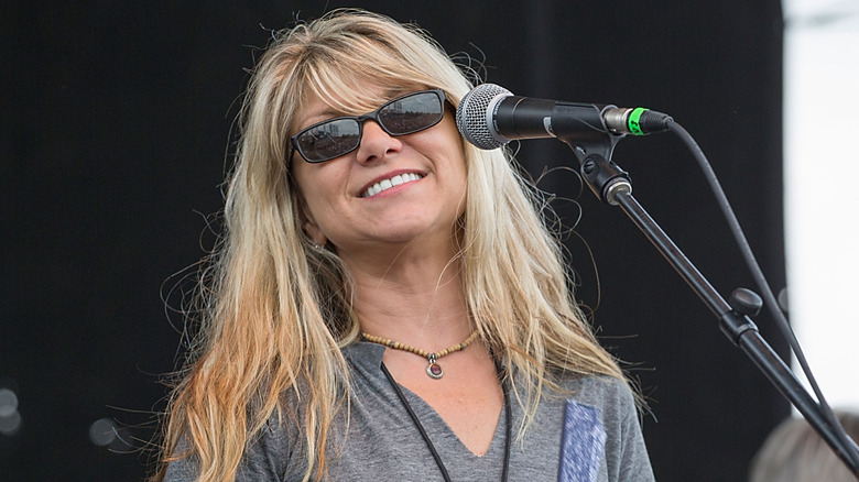 Paula Carlene Nelson smiling and wearing sunglasses onstage