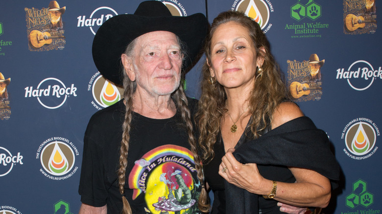 Willie Nelson standing next to Annie D'Angelo