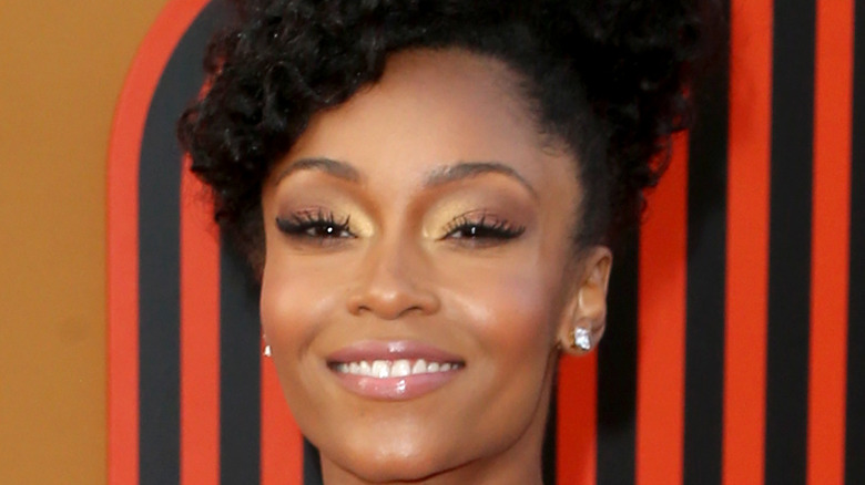 Yaya DaCosta smiles at an event