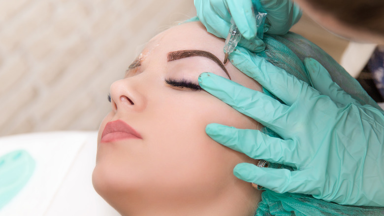 Woman getting an eyebrow procedure