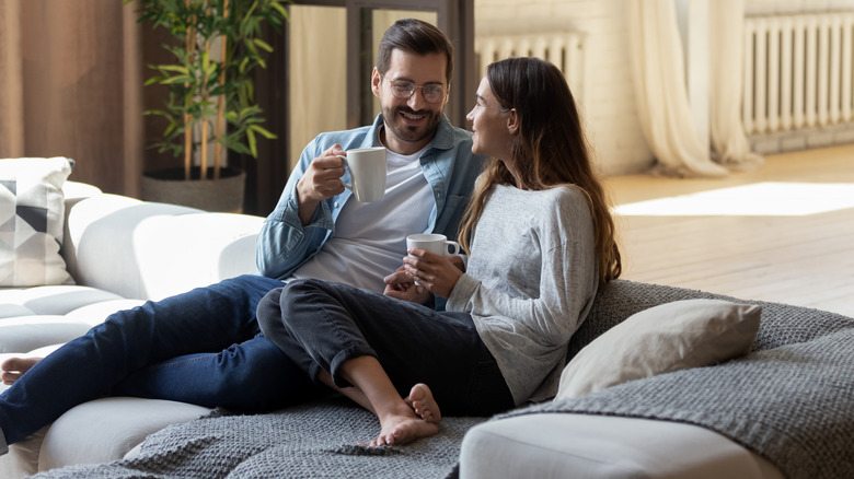 couple drinking coffee on couch