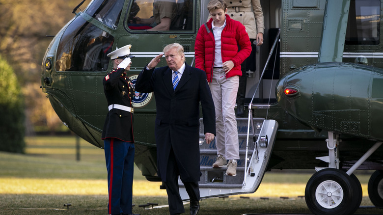 Barron Trump exiting a helicopter with Donald Trump