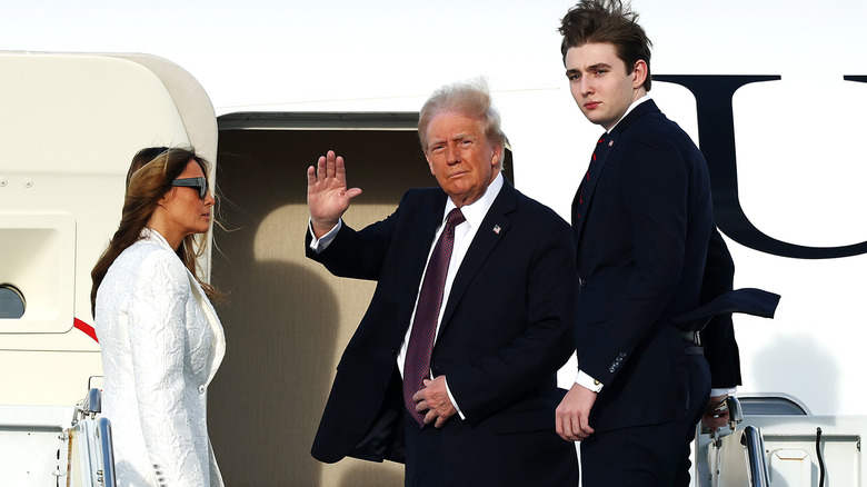 Barron Trump outside of an aircraft with his parents