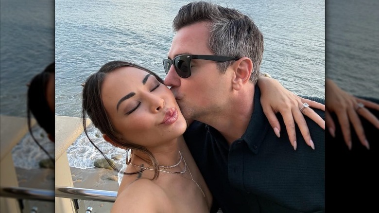 Chris Long kissing Janel Parrish on the cheek as the couple takes a selfe