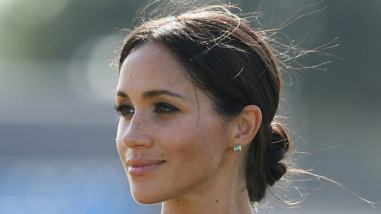 Meghan Markle smiles at an event