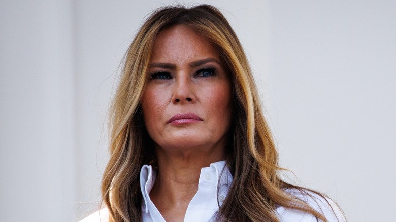 Melania Trump listens as Donald Trump delivers remarks