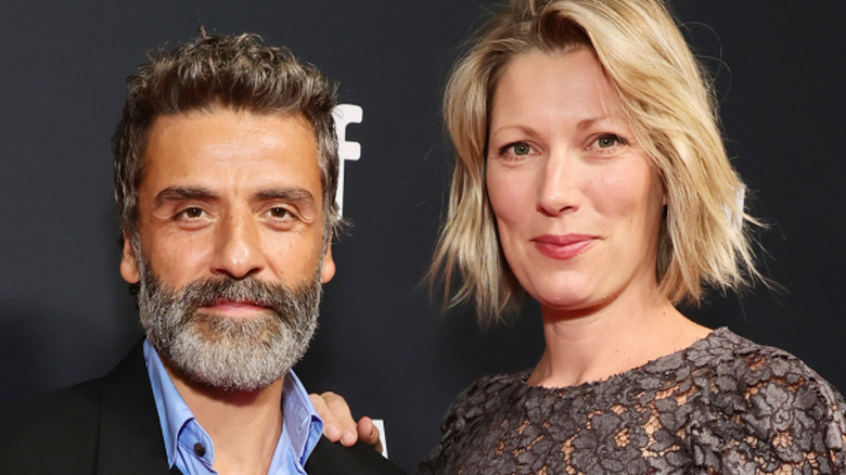 Elvira Lind with hand on Oscar Isaac's shoulder