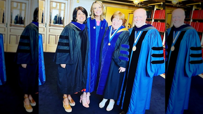 Savannah Guthrie smiling in her graduation gown with a group of people