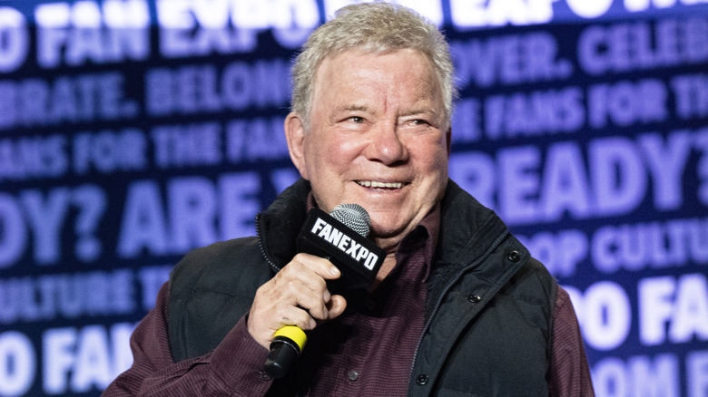 William Shatner smiling with a microphone
