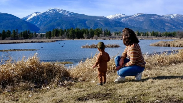 Bianca Grimes and her son looking at a lake and mountains in Montana