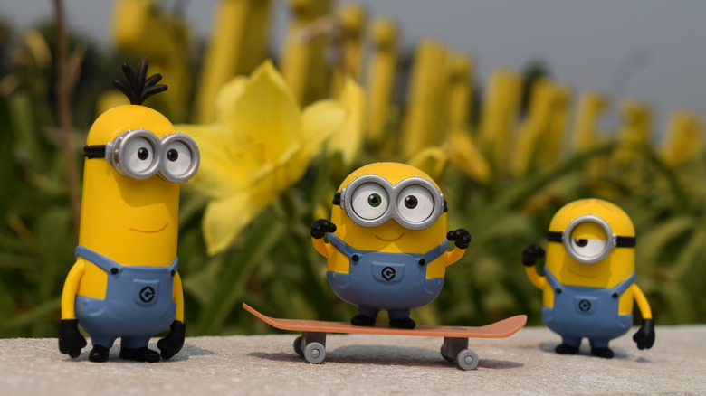 Three minions, one on skateboard