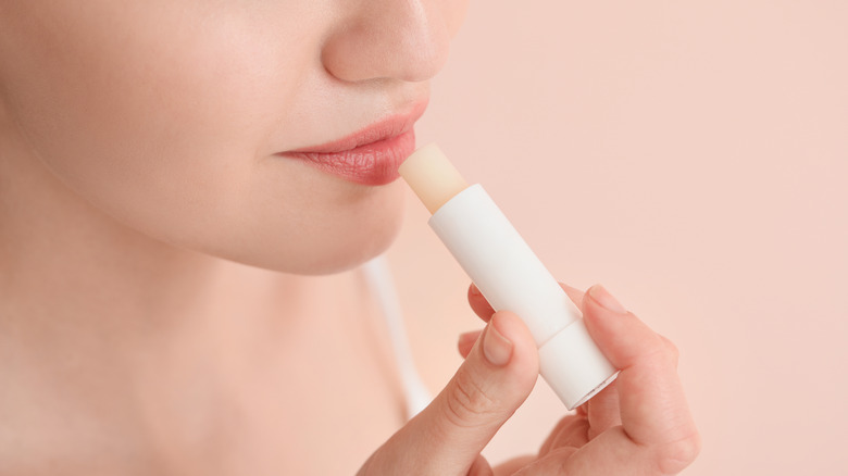 Woman applying lip balm