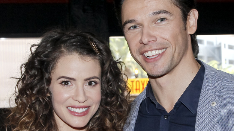 Paul Telfer and Linsey Godfrey pose for a photo. 