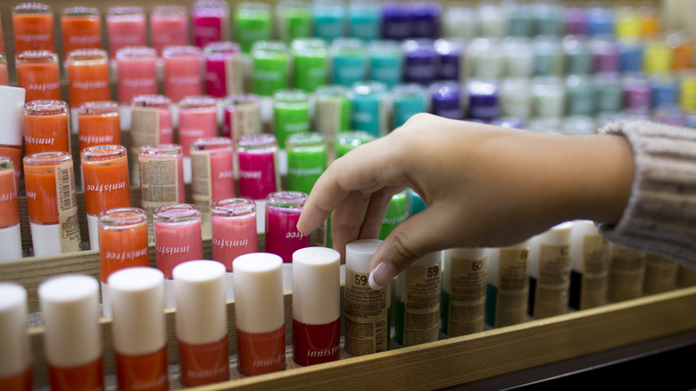 A customer selects nail polish from an Innisfree store.