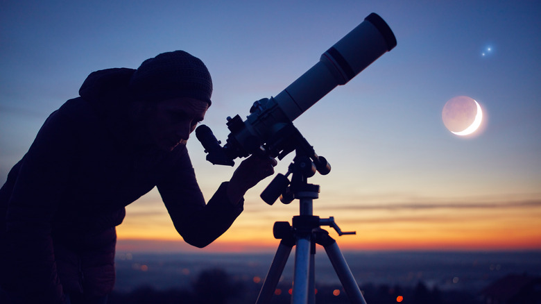 Person uses a telescope