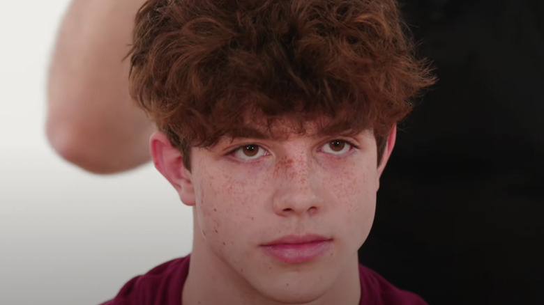 A young man with the wet mop haircut