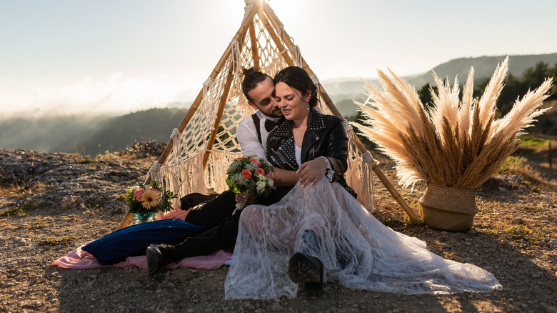 couple sitting on a cliff