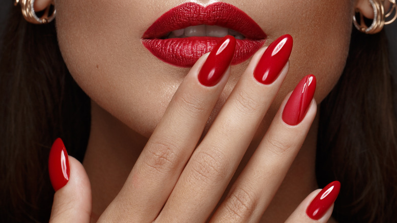 red lips and nails posed together