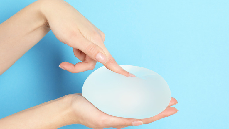 Woman touching saline breast implant