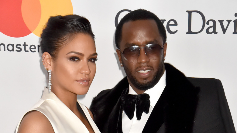 Diddy smiling next to Cassie Ventura