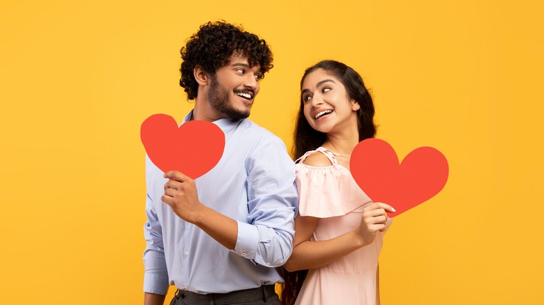 a couple holding hearts