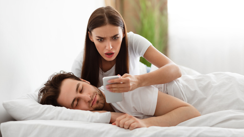 Woman looking at partner's phone