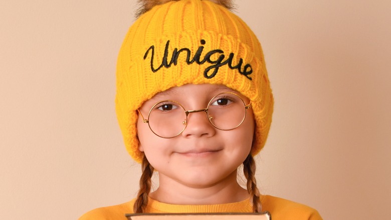 Child with glasses wear unique hat