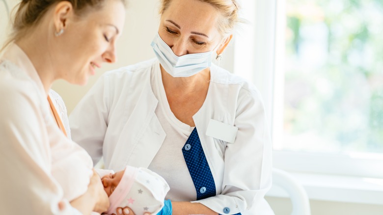 Mom and new baby with healthcare provider