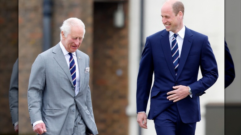 King Charles and Prince William walking and laughing