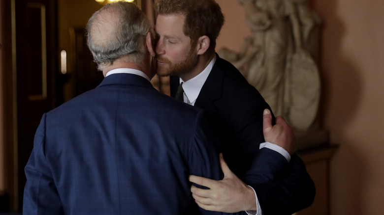 King Charles kisses Prince Harry on the cheek